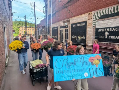 Community Pride: Catholic school students volunteer with DLH, beautify business district for fall